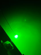 Glow Magnet light glowing green under dark water at night
