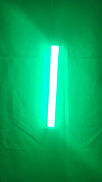 Glow Magnet LED tube lit up, throwing green light through the water